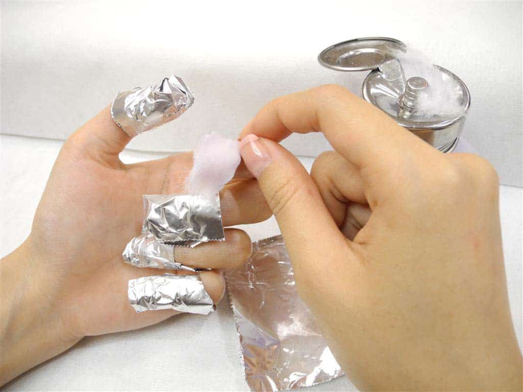 Wrap the nail with acetone-soaked cotton pads and foil